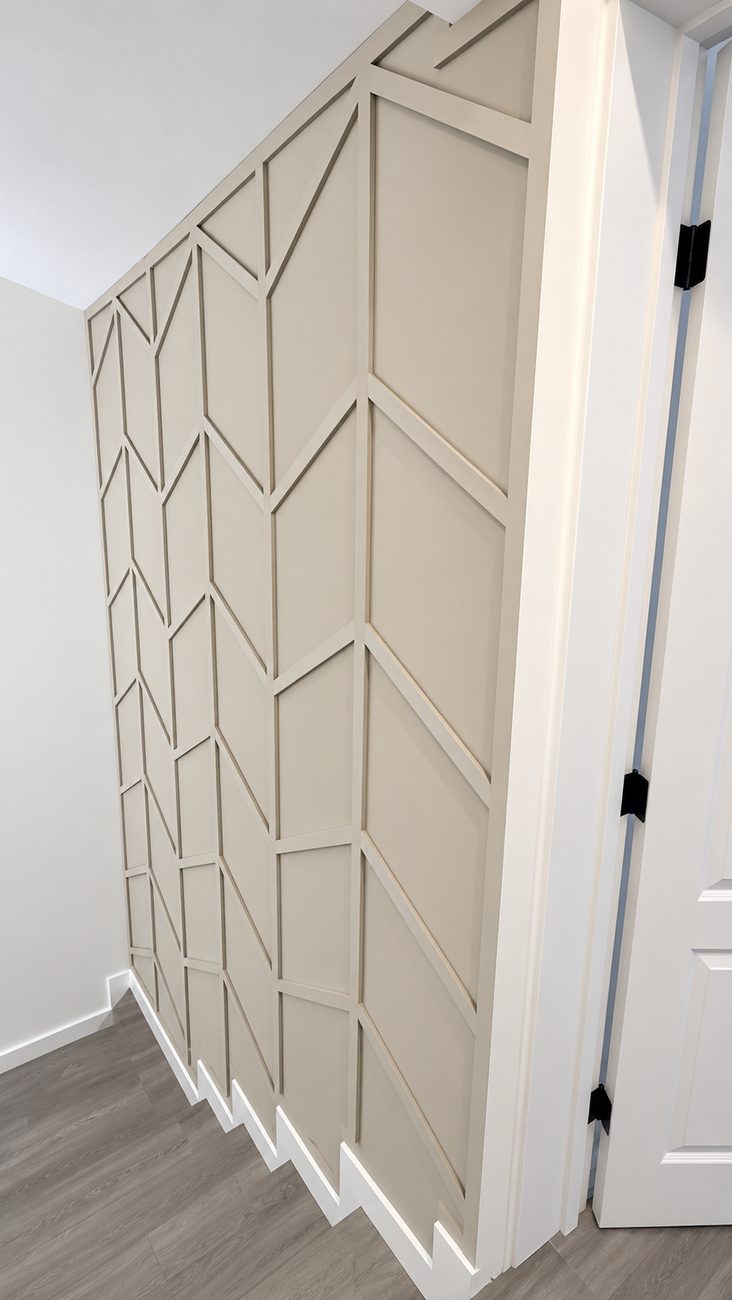 Greige accent wall with chevron batten pattern and a stepped baseboard detail