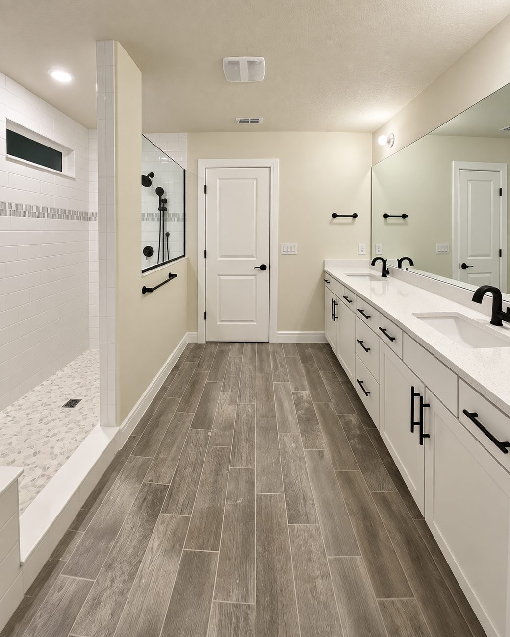 Walk-in shower with a built-in bench and pebble mosaic pan, subway tile with a glass mosaic band and matte black fixtures