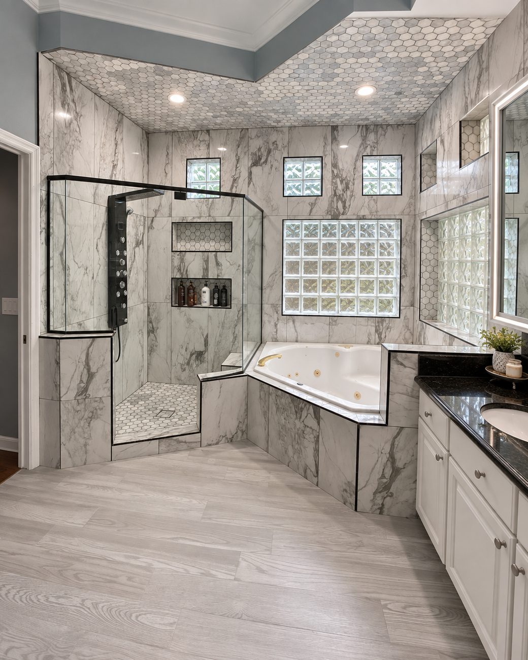 Master bathroom in marble-look porcelain with black pencil trim, hexagon mosaic on the ceiling and shower pan, corner shower with a built-in seat and niches, and a corner jetted tub